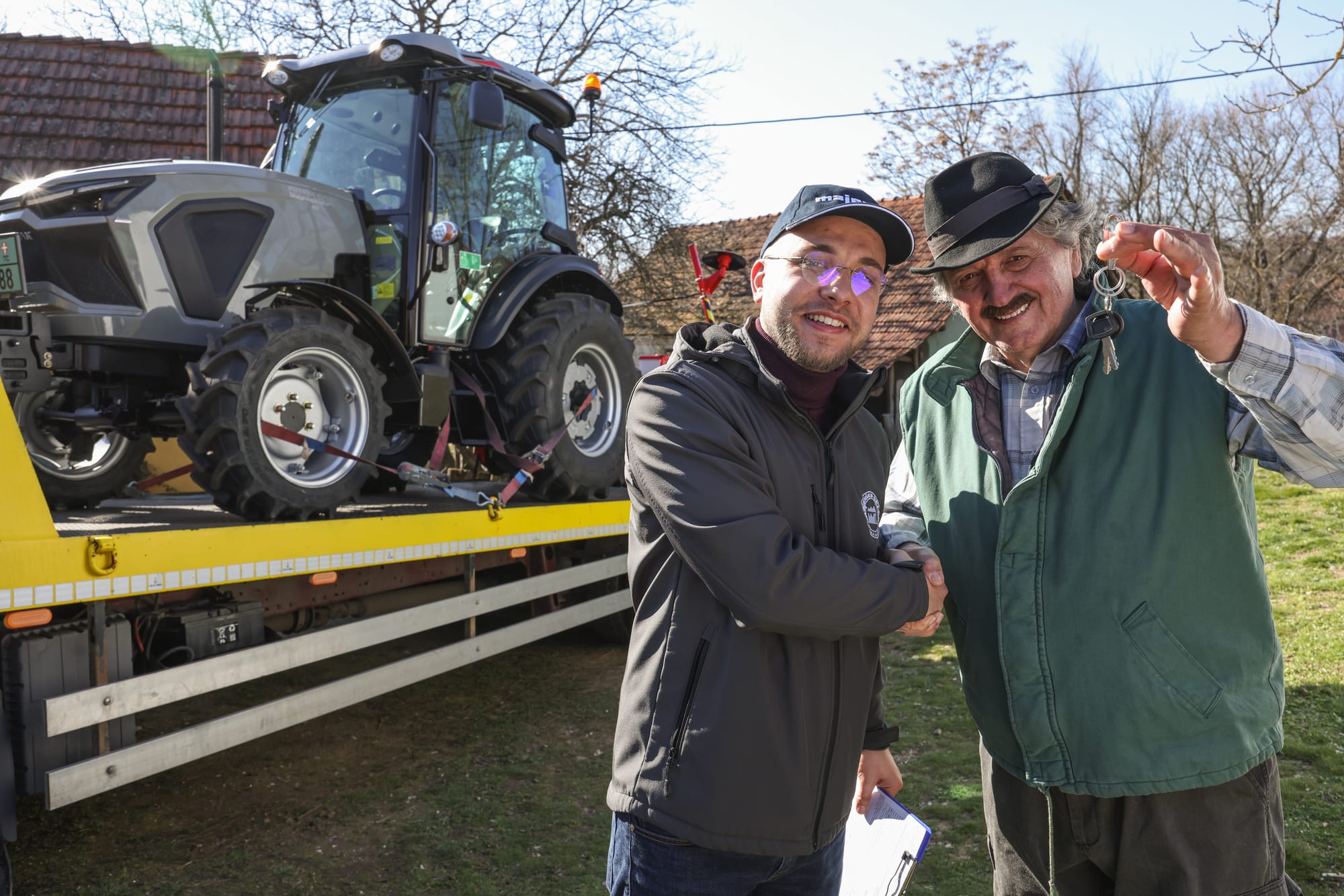 A satisfied customer taking over a tractor