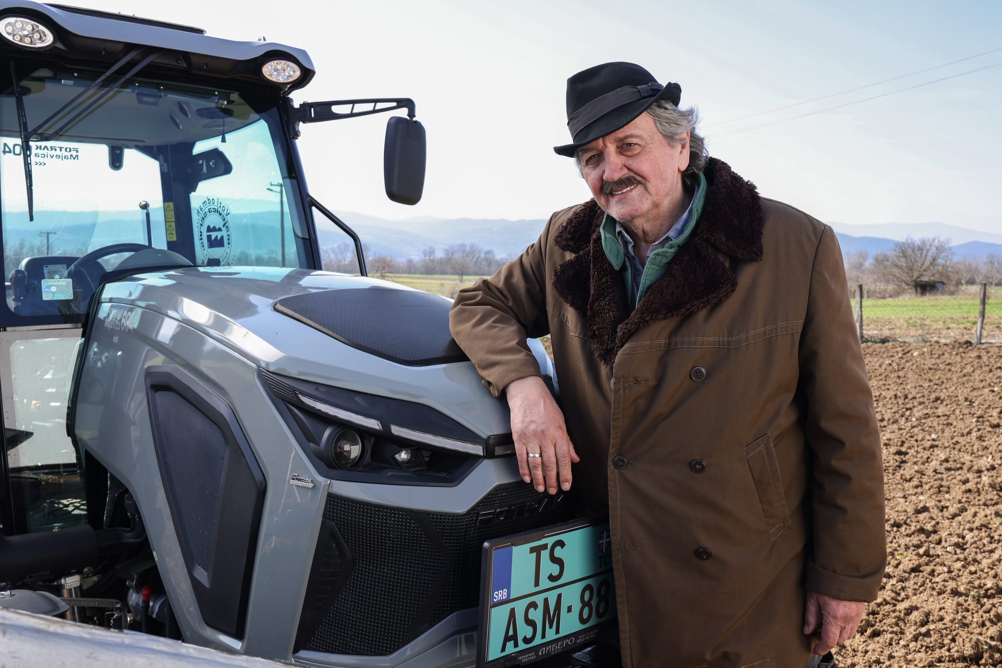 Farmer with a tractor in the field